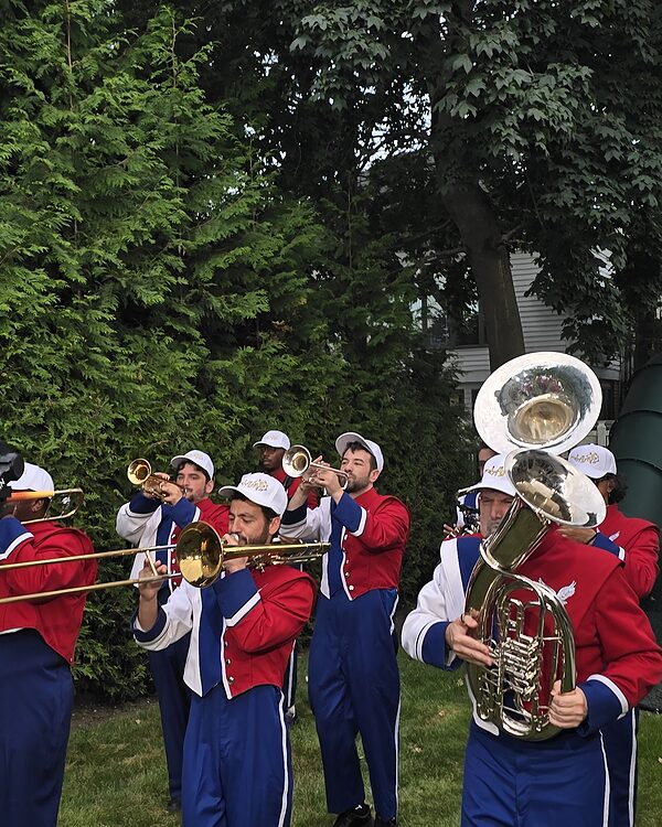 Trumpets and trombone raised mid-phrase